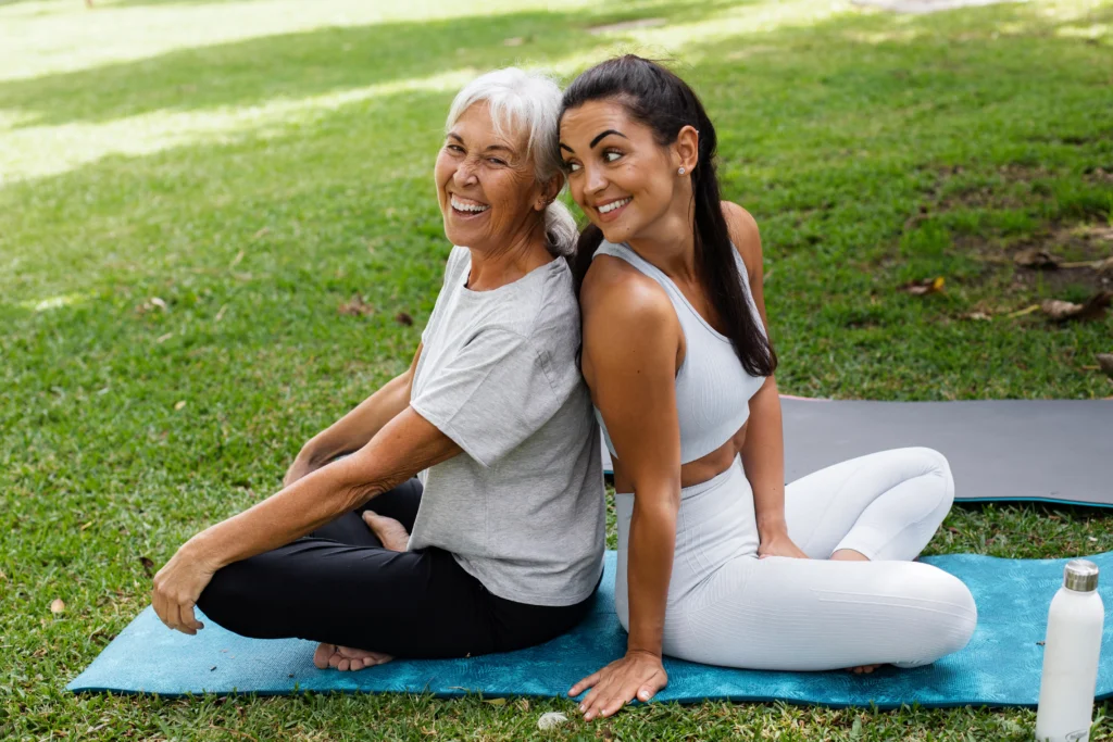 Friends practicing yoga together in a park